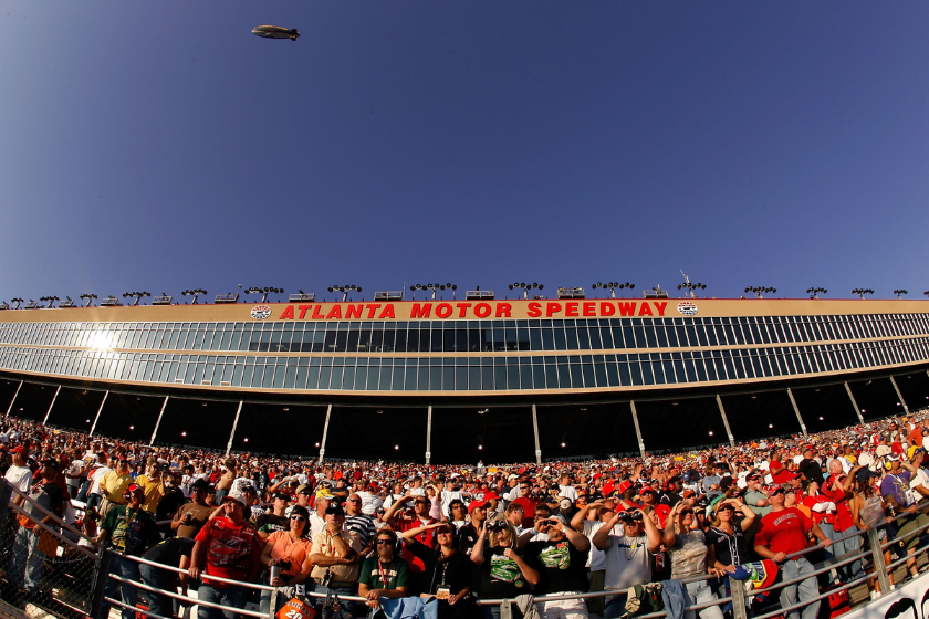 fans watch race action at atlanta motor speedway as blimp flies overhead