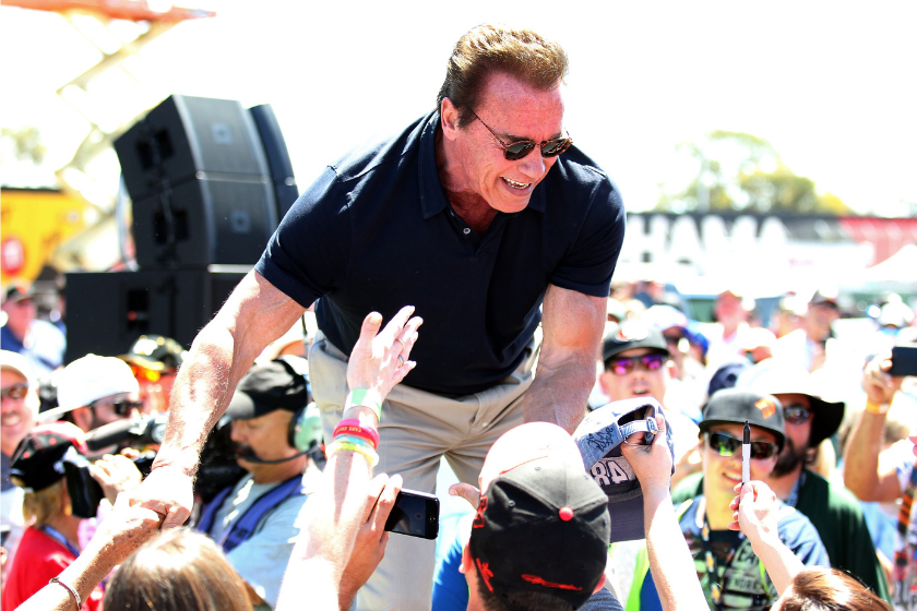 Actor and former governor of California Arnold Schwarzenegger greets fans prior to the NASCAR Sprint Cup Series Toyota/Save Mart 350 at Sonoma Raceway on June 28, 2015 in Sonoma, California