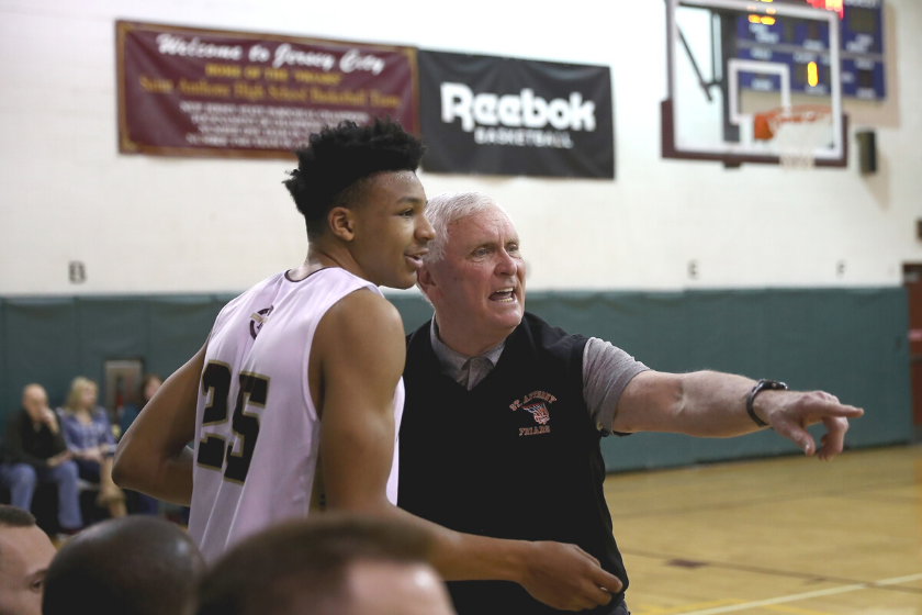 St. Anthony's head coach Bob Hurley instructs a player in a high school basketball game.