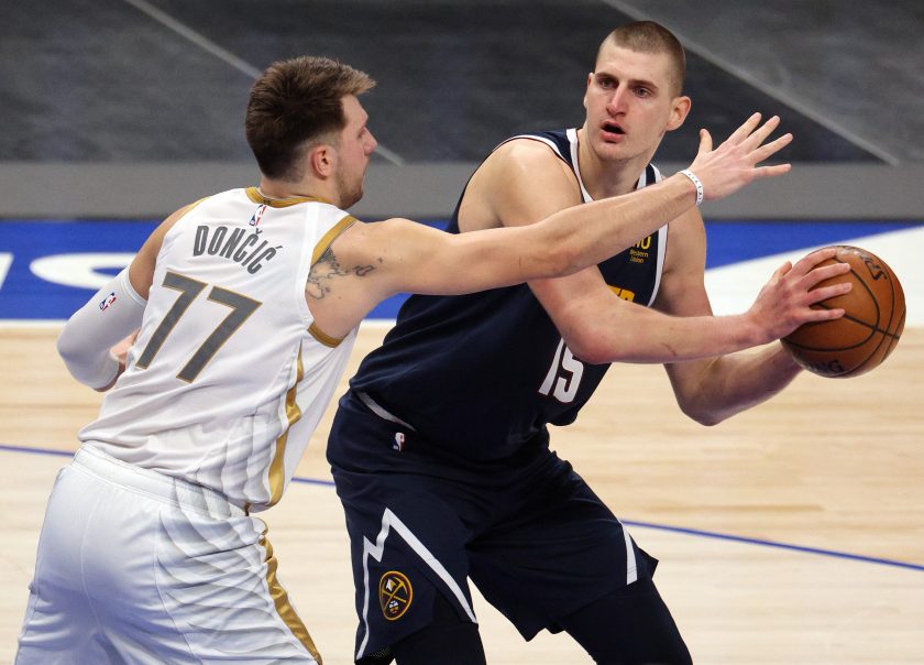 Nikola Jokic # 15 of the Denver Nuggets controls the ball against Luka Doncic # 77 of the Dallas Mavericks in the third quarter at American Airlines Center