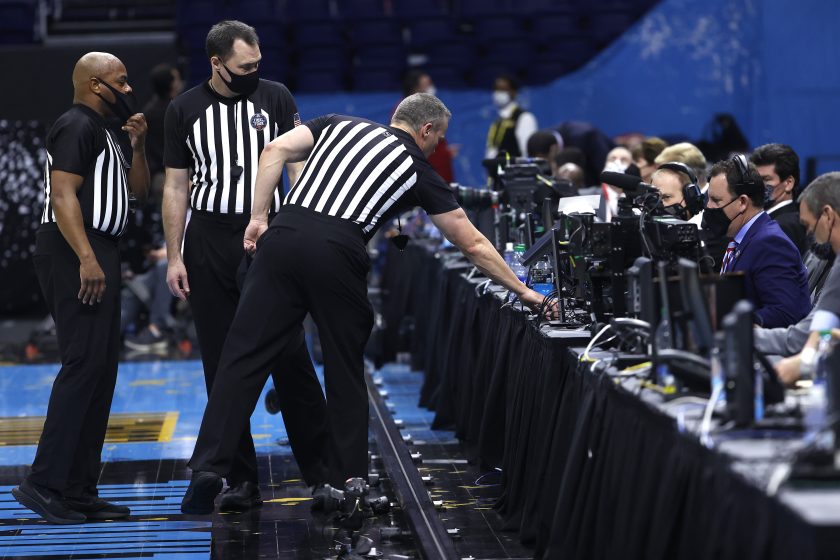 Referees review a play in the second half during the 2021 NCAA Final Four semifinal between the UCLA Bruins and the Gonzaga Bulldogs.