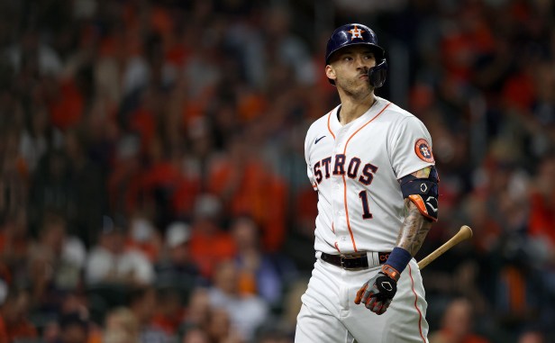 Carlos Correa heads back to the Astros dugout after striking out.