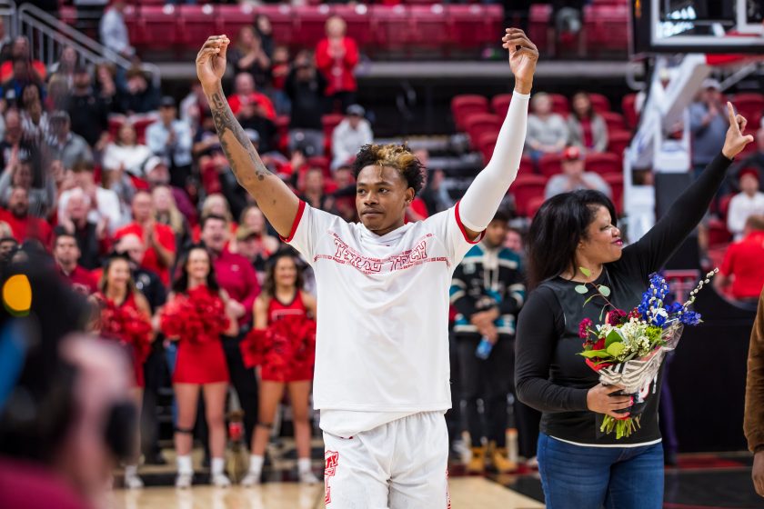 Adonis Arms raises his arms during senior night in 2022.