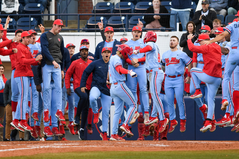 Ole Miss Baseball players celebrate a home run at home plate.