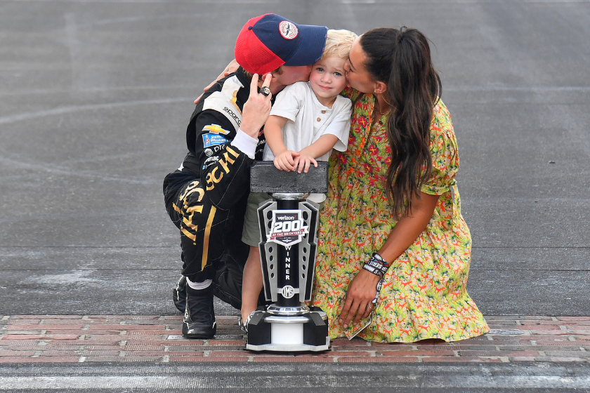 Tyler Reddick and girlfriend Alexa De Leon kiss son Beau on cheek after Tyler won 2022 Verizon 200 at Indianapolis Motor Speedway