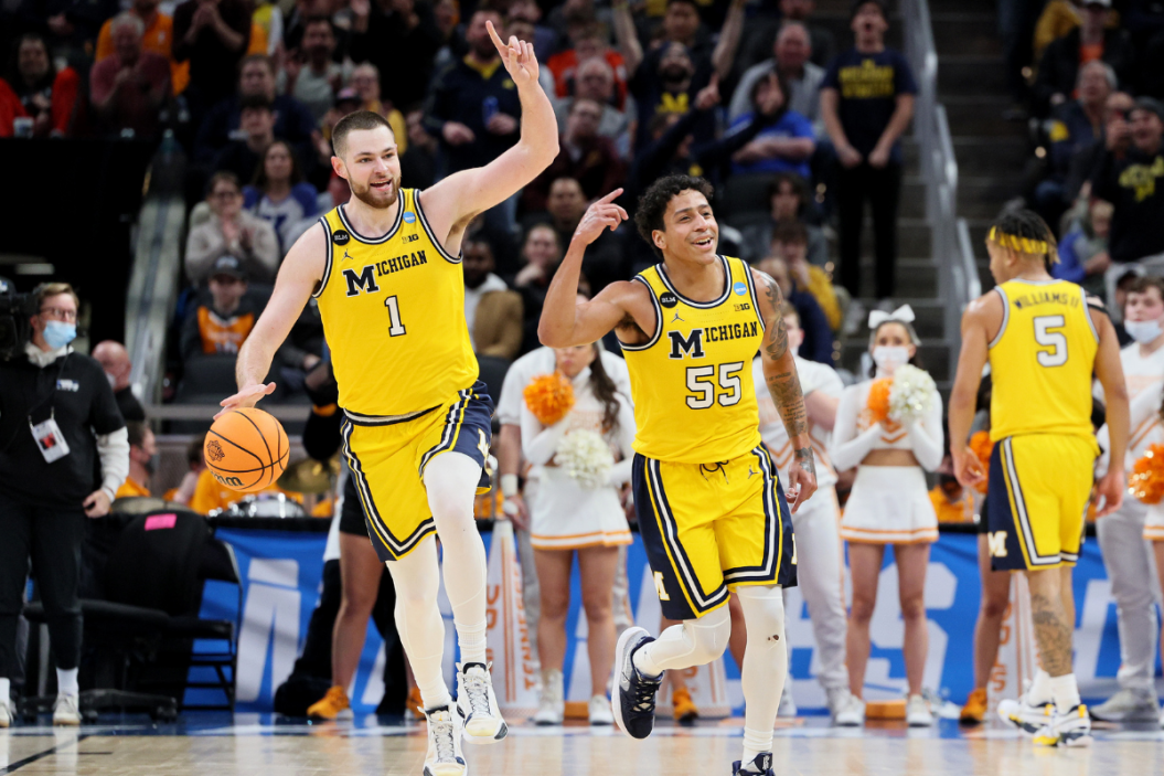 Michigan celebrates their supset over Tennessee