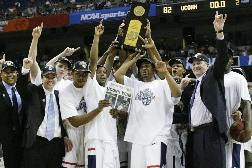 The UConn Huskies celebrate with the trophy after defeating the Georgia Tech