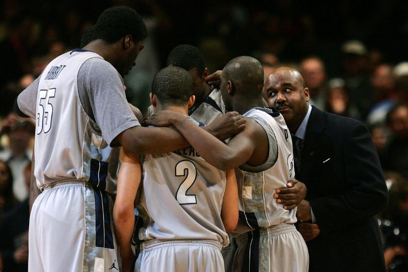 Head coach John Thompson III of the Georgetown Hoyas huddles with his team