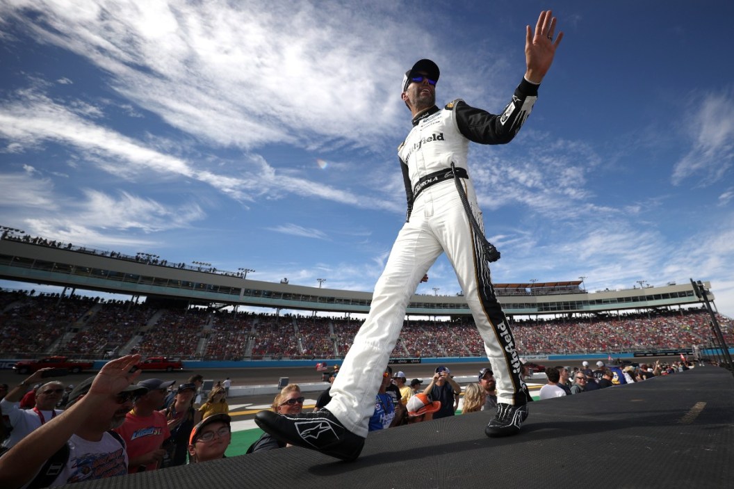 Aric Almirola waves to fans as he walks onstage during pre-race ceremonies prior to the NASCAR Cup Series Championship at Phoenix Raceway on November 07, 2021 in Avondale, Arizona