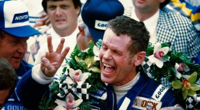 bobby unser holding up three fingers in victory lane at 1981 indy 500