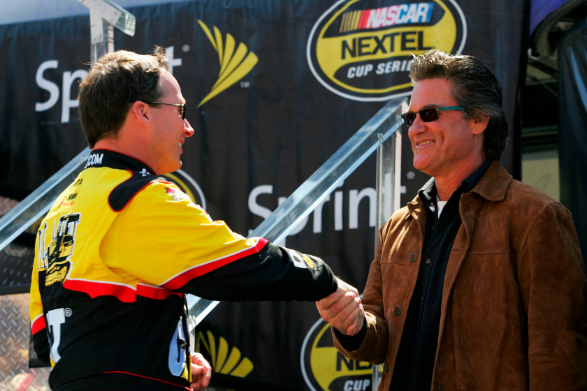 Dave Blaney, driver of the #22 Caterpillar Toyota, greets actor Kurt Russell during driver introductions for the NASCAR Nextel Cup Series Kobalt Tools 500 at Atlanta Motor Speedway on March 18, 2007 in Hampton, Georgia