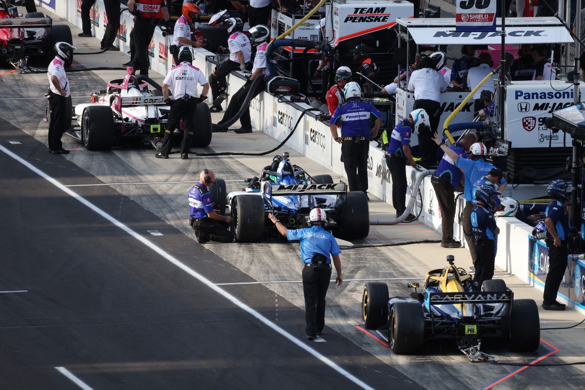 IndyCar drivers wait in the pits during qualifications for the Big Machine Spiked Coolers Grand Prix on August 13, 2021 on the Indianapolis Motor Speedway Road Course in Indianapolis, Indiana