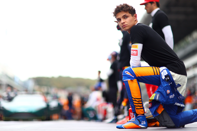 Lando Norris kneels in support of the We Race As One initiative before the F1 Grand Prix of Russia at Sochi Autodrom on September 26, 2021 in Sochi, Russia