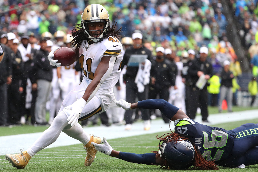 Alvin Kamara #41 of the New Orleans Saints runs with the ball against Shaquill Griffin #26 of the Seattle Seahawks