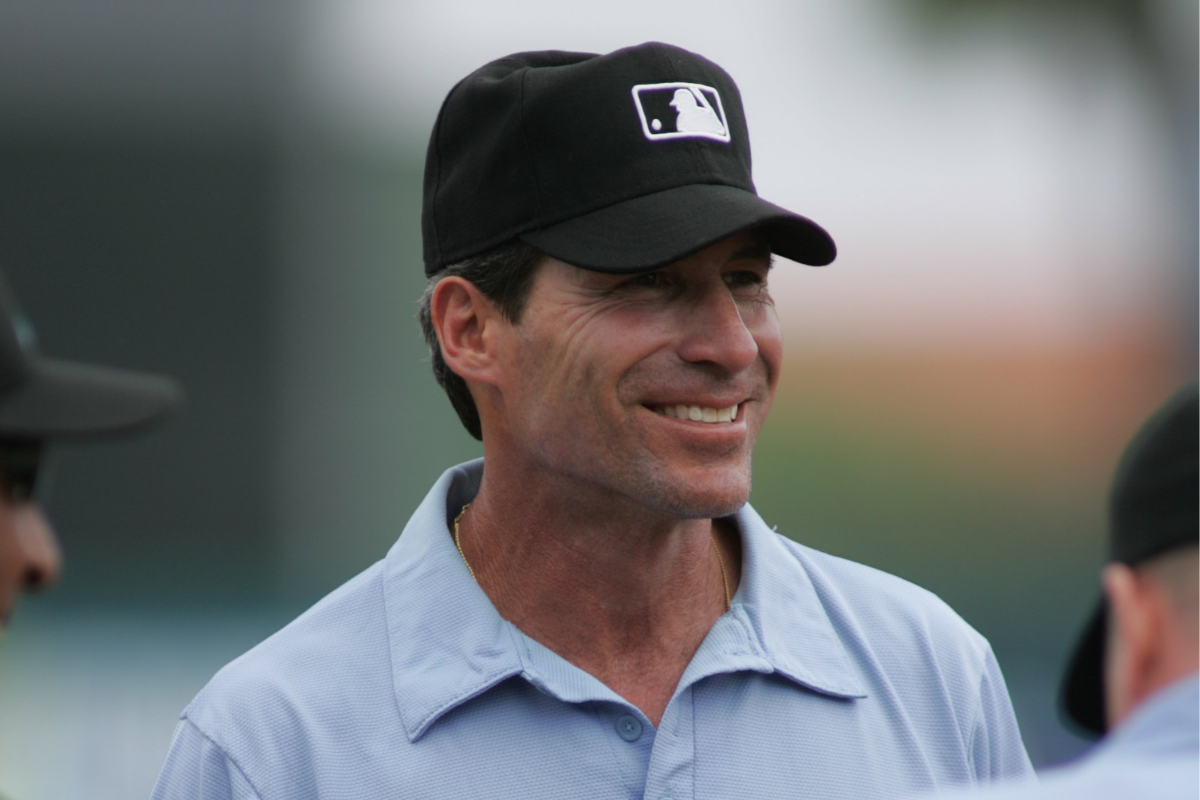 Angel Hernandez smiles and laughs before a Spring Training Game