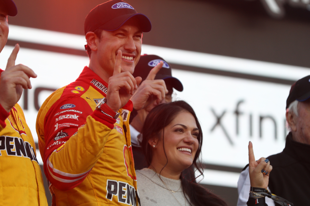 Joey Logano celebrates with his wife Brittany in victory lane after winning 2022 NASCAR Cup Series Championship at Phoenix Raceway
