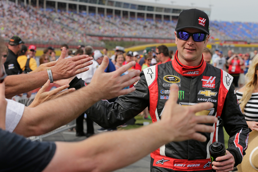 Kurt Busch gets high-fives from fans after arriving for the start of the NASCAR Sprint Cup series Coca-Cola 600 auto race at Charlotte Motor Speedway in Concord, N.C., Sunday, May 25, 2014. Busch finished sixth in the Indianapolis 500 race earlier