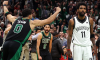 Jayson Tatum celebrates a buzzer-beating shot for the Celtics as Kyrie Irving looks on.