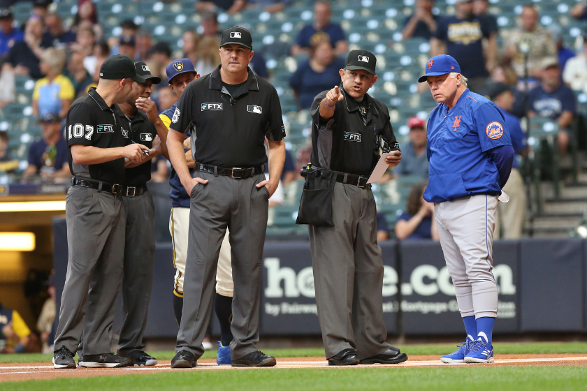 New York Mets manager Buck Showalter (11) takes ground rules from umpire Alfonso Marquez (72) during a game between the Milwaukee Brewers and the New York Mets
