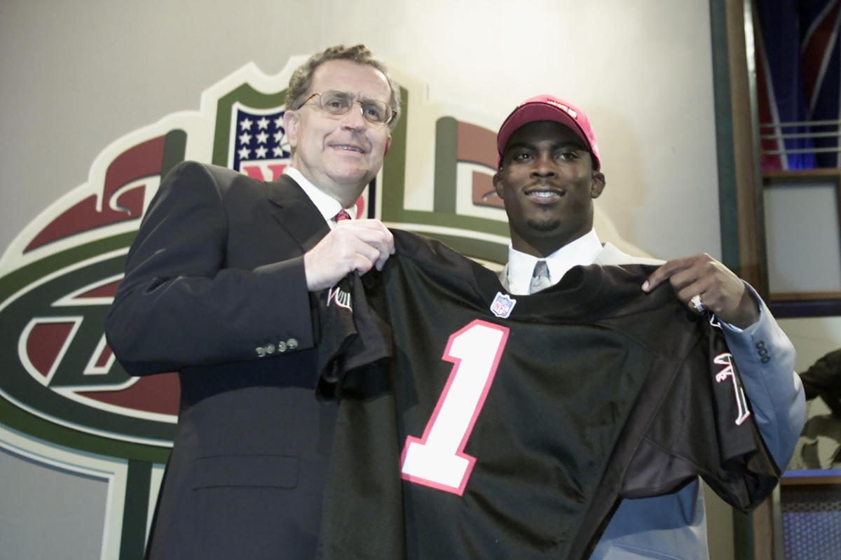 Michael Vick holds his jersey after being drafted in 2001.