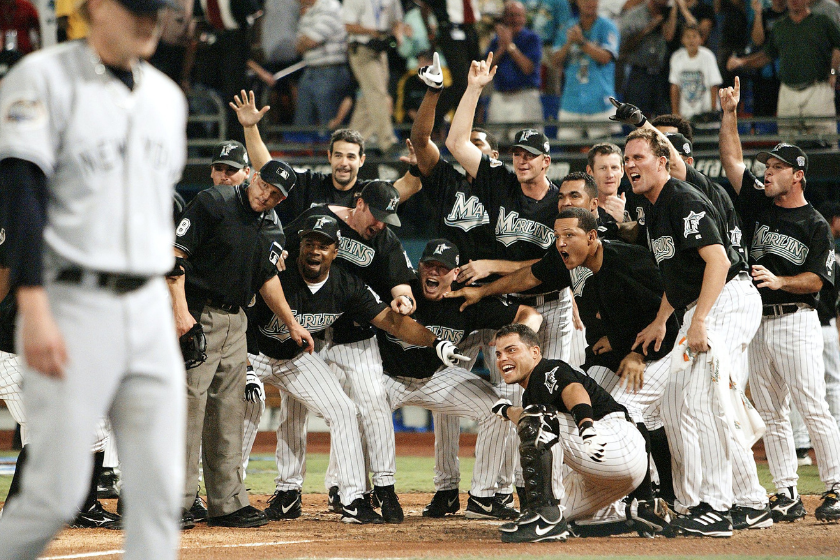 The 2003 Florida Marlins gather around home plate to welcome Alex Gonzalez home after walking off the Yankees.