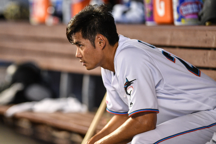 Wei-Yin Chen #20 of the Miami Marlins in the dugout after giving up a two run home run to Jean Segura #2 of the Philadelphia Phillies in the fourteenth inning at Marlins Park