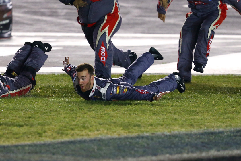 Austin Dillon and his crew slide in the infield grass in celebration of winning the Monster Energy NASCAR Cup Series Coca-Cola 600 at Charlotte Motor Speedway on May 28, 2017 in Charlotte, North Carolina