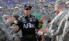 Carl Edwards high-fives members of the military during pre-race driver introductions prior to the NASCAR Sprint Cup Series 5-Hour Energy 400 at Kansas Speedway on May 10, 2014 in Kansas City, Kansas