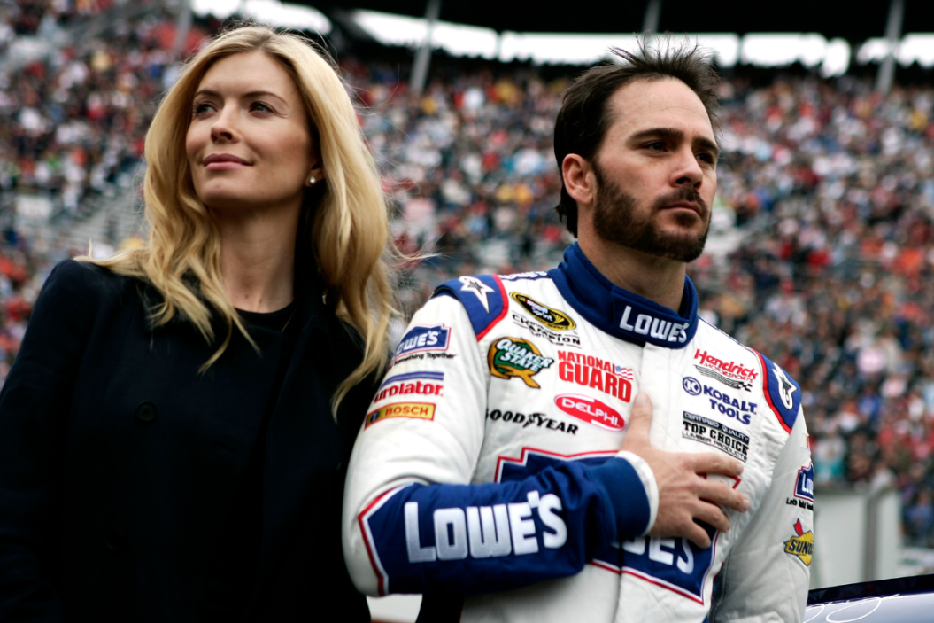 Jimmie Johnson stands on the grid with his wife Chandra prior to the start during the NASCAR Sprint Cup Series Food City 500 at Bristol Motor Speedway on March 21, 2010 in Bristol, Tennessee
