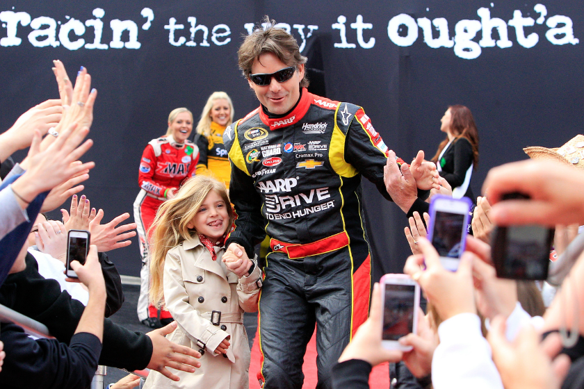 Jeff Gordon high-fives fans during driver introductions prior to the NASCAR Sprint Cup Series Food City 500 at Bristol Motor Speedway on March 17, 2013 in Bristol, Tennessee