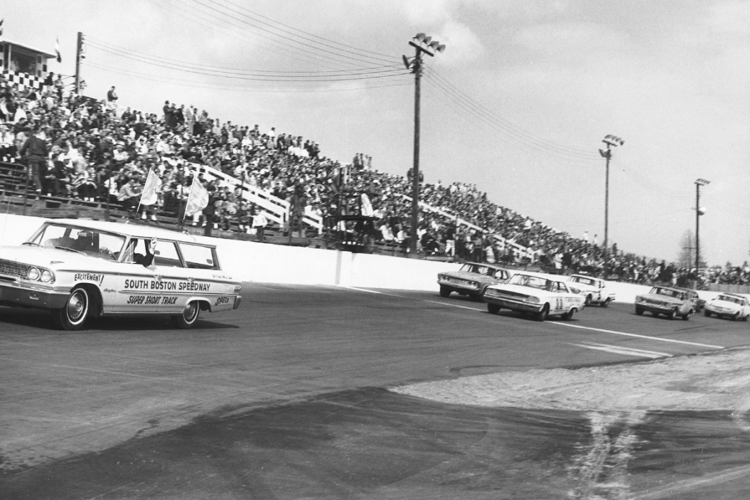 The start of the South Boston 400 NASCAR Cup race at South Boston Speedway. Ned Jarrett (No. 11) leads from the pole, as eventual race winner Richard Petty races from outside row one. Jim Paschal and Billy Wade (No. 5) started on row two
