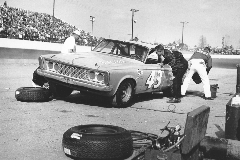 Lee Petty confers with his driver (and son) Richard Petty while he makes a pit stop during a NASCAR Cup race at South Boston Speedway. Petty won both Cup races held at South Boston during the year