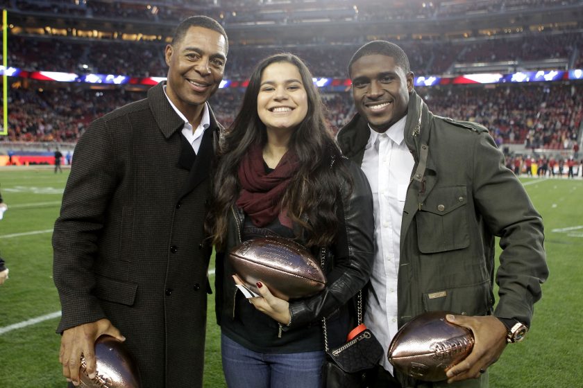 Sydney Seau poses for a picture with Marcus Allen and Reggie Bush in 2015.