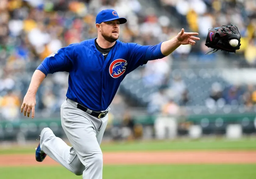 Jon Lester throws his glove to first in 2016.