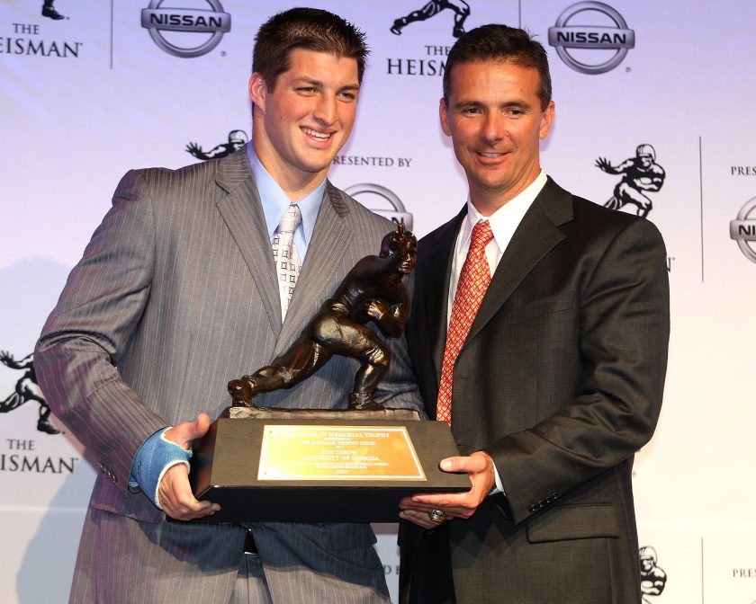 Tim Tebow and Urban Meyer hold the 2007 Heisman Trophy.