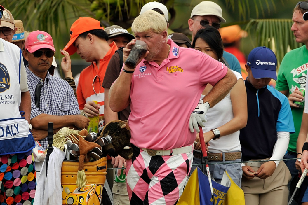 John Daly enjoys a Diet Coke before teeing off.