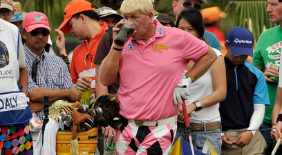 John Daly enjoys a Diet Coke before teeing off.