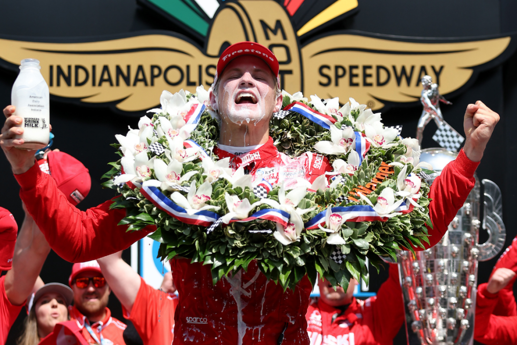 Marcus Ericsson of Sweden celebrates in Victory Lane by pouring milk on his head after winning 2022 Indy 500