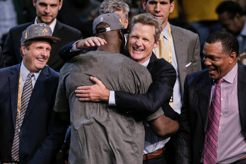 Steve Kerr embraces Draymond Green after the Warriors capture the 2015 NBA title.