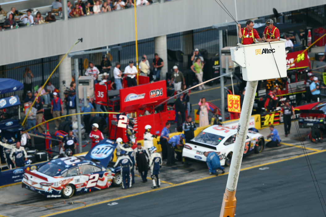 Track workers take down an aerial Fox Sports camera in the infield from a cherry picker during a red flag in the 2013 Coca-Cola 600 at Charlotte Motor Speedway