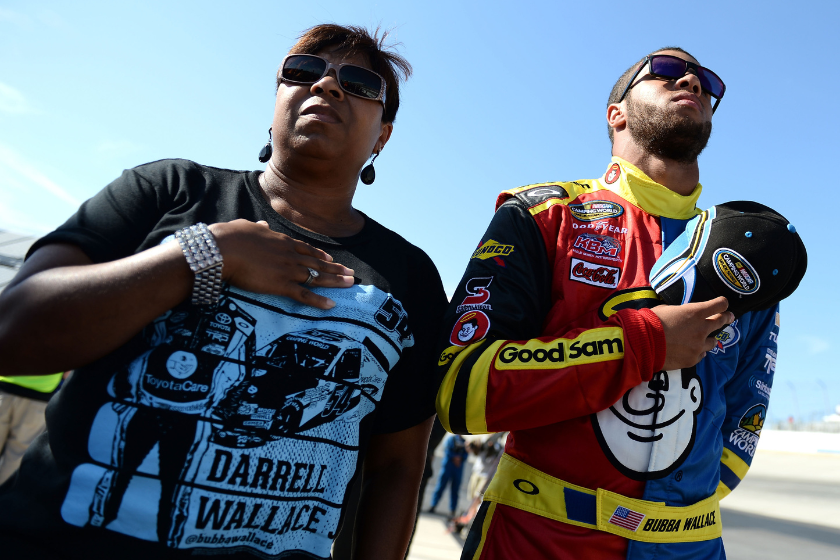 Bubba Wallace, driver of the #54 Camping World Toyota, stands with his mother, Desiree, during pre-race ceremonies for the NASCAR Camping World Truck Series Lucas Oil 200 at Dover International Speedway on May 31, 2013 in Dover, Delaware