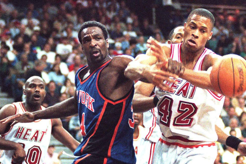 Charles Oakley fights for a rebound against the Miami Heat