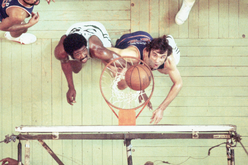 Dave DeBusschere goes for a rebound against the Boston Celtics.