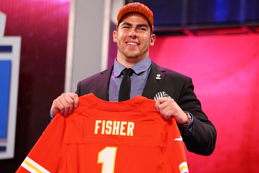 Eirc Fisher holds up a Kansas City Chiefs jersey ater being selected first overall by the Chiefs.