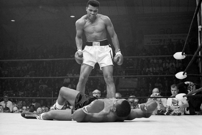 Muhammad Ali stands over his opponent.