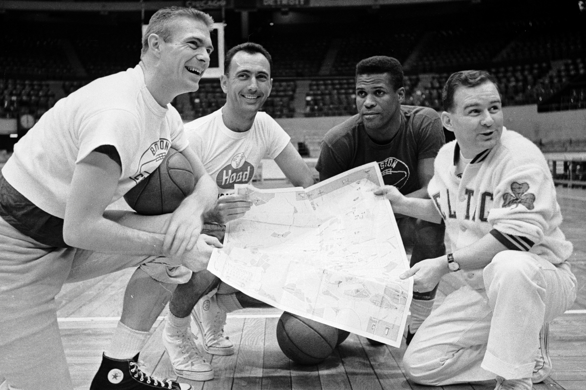 NBA Stars and Soviet Union basketball players look at a map.