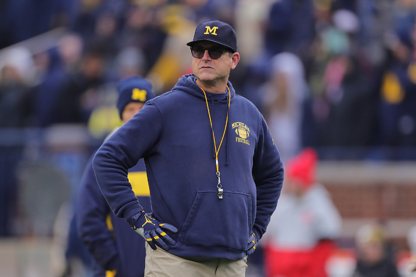 Jim Harbaugh looks on a his Michigan Wolverines warm up prior to a game
