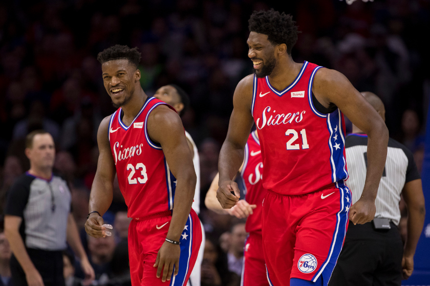 Jimmy Butler and Joel Embiid react to a play as members of the Philadelphia 76ers.