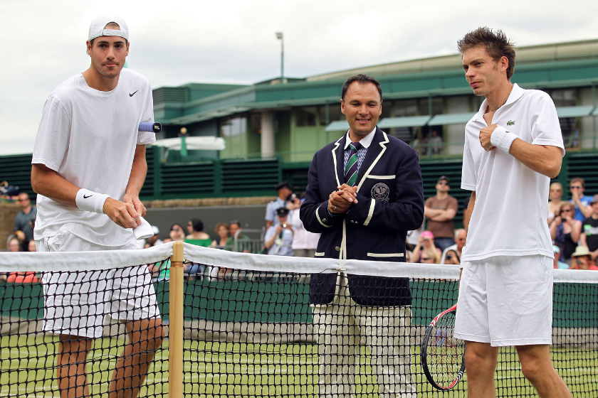 John Isner and Nicolas Mahut meet at the net int he 2010 Wimbledon matchup.