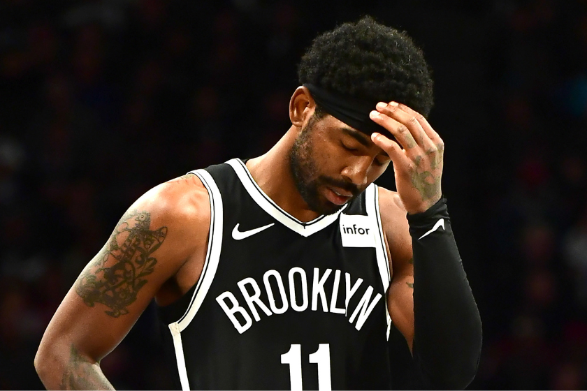 Kyrie Irving readjusts his headband during a Brooklyn Nets game.